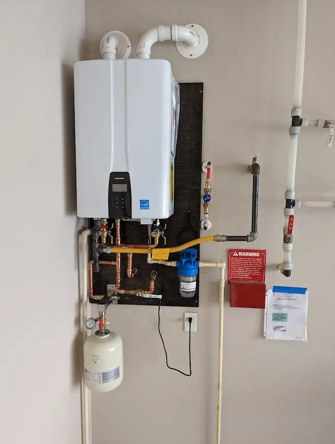 Professional plumber installing copper piping in a Polson home